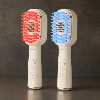 Two HAIRECOVER scalp brushes side by side, one with tips glowing red and one glowing blue