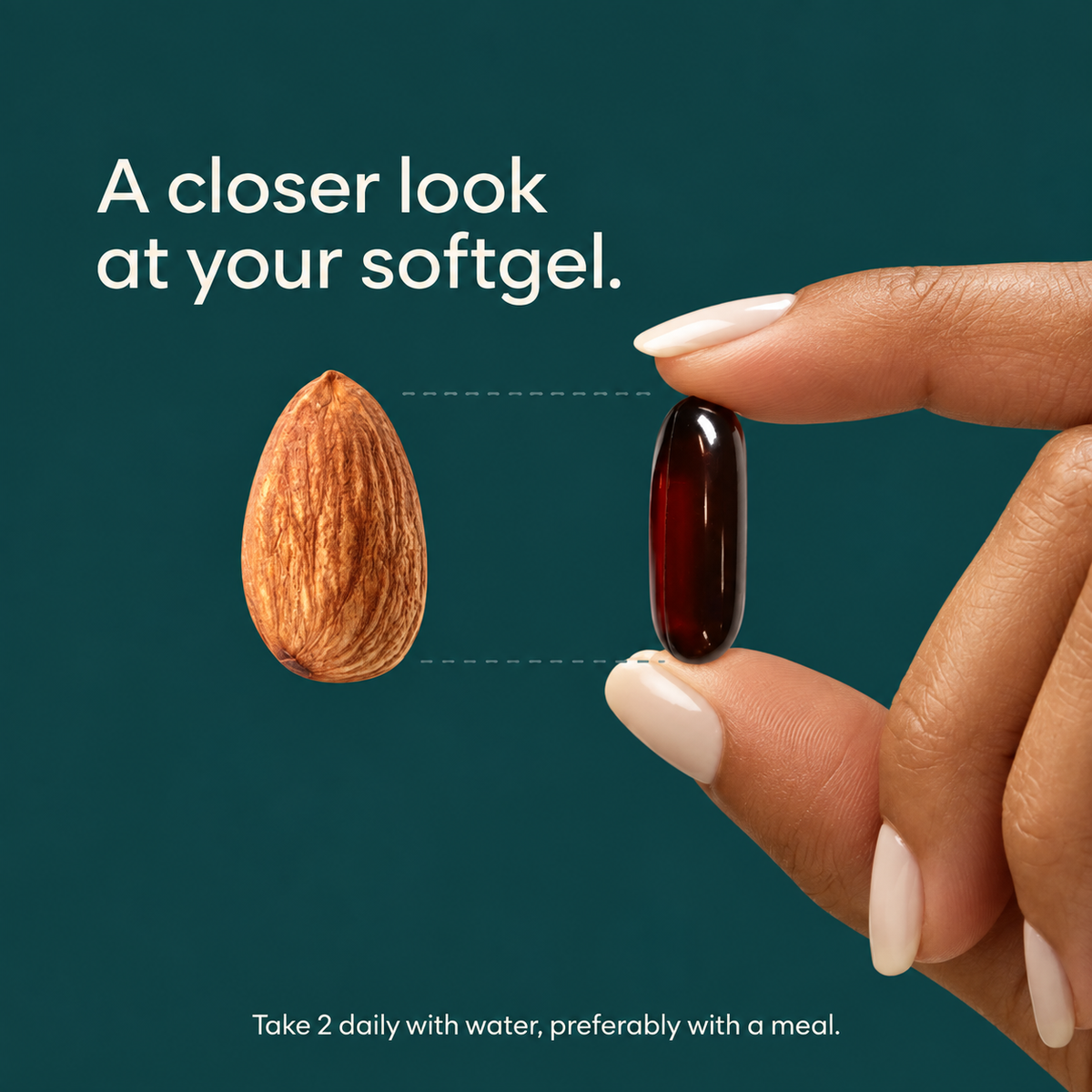 A hand holding one dark oblong softgel beside an almond for a visual size comparison.
