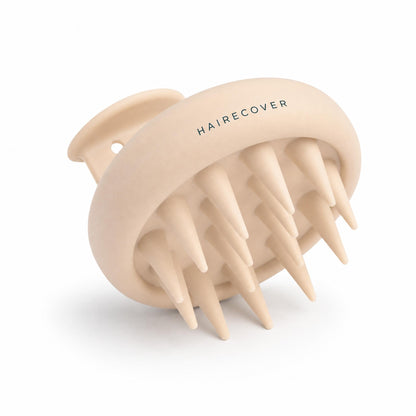 HAIRECOVER silicone scalp massager in cream with soft conical bristles, on white